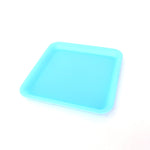 Silicone rolling tray in blue, perfectly square. Side view.